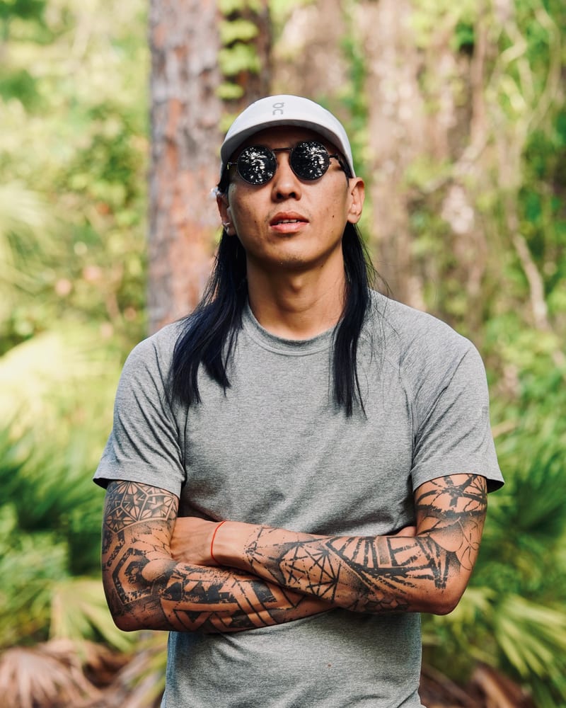 Will Pei Yuan on a trail, in a grey T-shirt and cap
